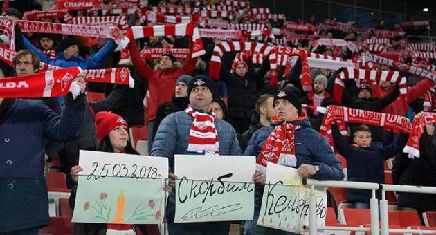 Spartak Moscow's fans hold handmade posters reading 'March 25, 2018, mourn, remember, Kemerovo' during the Russian premier league soccer match between Spartak Moscow and Tosno at the Otkrytiye Arena in Moscow, Russia, Saturday, March 31, 2018. Russian soccer teams played in near silence on Saturday as the country mourned 64 people killed in a shopping mall fire. Fan groups across the country agreed not to sing for the first halves of their league games as a mark of respect after Sunday's fire in the Siberian city of Kemerovo shook the nation. (AP Photo/Ivan Vodopianov)