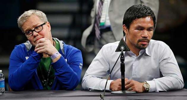 In this May 2, 2015, file photo, trainer Freddie Roach, left, listens as Manny Pacquiao answers reporter questions during a news conference following Pacquiao's welterweight title fight in Las Vegas. Pacquiao and Roach say their 16-year partnership has ended. Pacquiao disclosed his decision Friday, April 13, 2018, in the final sentence of a news release detailing his plans for his upcoming fight against Lucas Matthysse. (AP Photo/John Locher, File)