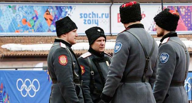 In this Jan. 30, 2014 file photo, Russian Cossack soldiers stand guard on a bridge at the ski resort Rosa Khutor in Krasnaya Polyana outside the Black Sea resort of Sochi, Russia, where the snow and sliding sports venues for the 2014 Winter Olympics are located. Around 200 Cossacks will be drafted in to provide security at 2018 World Cup games in Russia to help security forces around the stadium and airport. Some will double as entertainers with displays of horseback stunt-riding. (AP Photo/Gero Breloer, File)