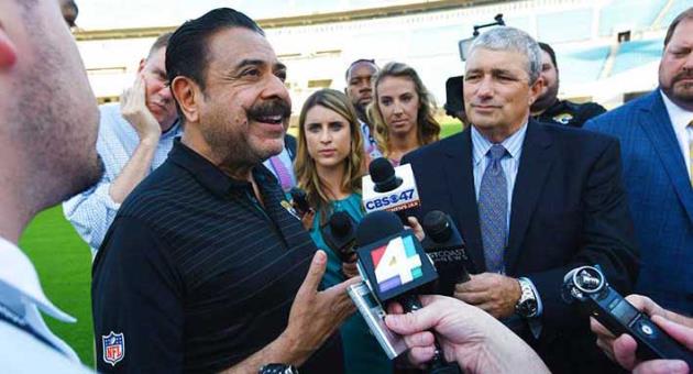 Jacksonville Jaguars owner Shad Khan, left, fields questions from the media on his interest in buying Wembley Stadium in London ahead of the Uniform Launch and Draft Party NFL football event at EverBank Field in Jacksonville, Fla., Thursday, April 26, 2018. The English Football Association has received an offer from Khan of about 600 million pounds ($840 million) for the national soccer stadium, which would continue to host England games and major cup finals after a sale. (Bob Self/The Florida Times-Union via AP)
