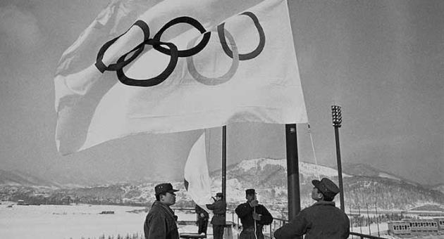 In this Jan. 23, 1972, file photo, members of Japan's self-defense ground forces raise Olympic Flags in Sapporo at Makomanai speed skating stadium in rehearsal of ceremony at official opening of Winter Olympic. The Japanese city of Sapporo seems to be having second thoughts about bidding for the 2026 Winter Olympics and could focus instead on the 2030 Games. (AP Photo, File)
