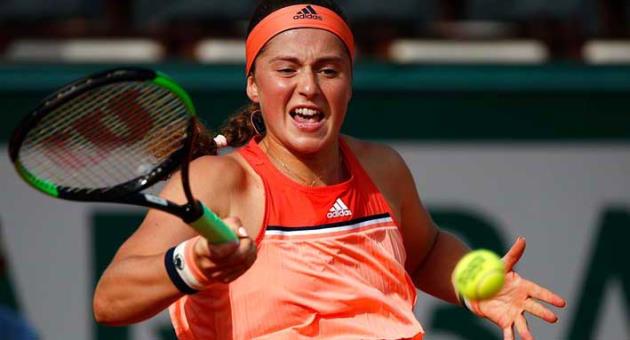 Latvia's Jelena Ostapenko returns the ball to Ukraine's Kateryna Kozlova during their first round match of French Open tennis tournament at the Roland Garros Stadium, Sunday, May 27, 2018 in Paris. (AP Photo/Christophe Ena)