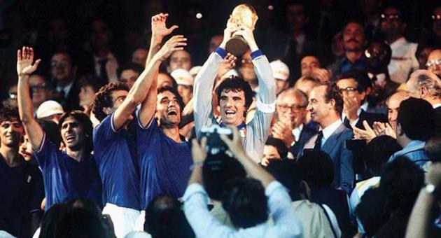 Veteran goalkeeper and Italy captain Dino Zoff lifts the FIFA World Cup after receiving it from King Juan Carlos of Spain.