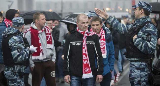 In this photo taken on Wednesday, April 18, 2018, police officers stop to check Spartak Moscow’s supporters before the a Russian Premier League Championship football match between Spartak Moscow and Tosno in Moscow, Russia. Photo:?AP