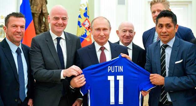 Russian President Vladimir Putin, center, poses for a photo with world soccer legends, former German soccer player Lothar Matthaus, left, FIFA President Gianni Infantino, second left, former Mexican soccer player Jorge Campos Navarrete, right, First Vice President of the Russian Football Union Nikita Simonyan, second right and former Danish soccer player Peter Schmeichel, background, during a meeting in the Kremlin in Moscow, Russia, Friday, July 6, 2018. (Alexei Druzhinin, Sputnik, Kremlin Pool Photo via AP)
