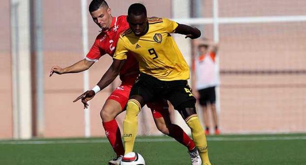 Belgium goalscorer Nani Dimata (in yellow) shields the ball away from the challenge of Jean Borg of Malta. Photo: Domenic Aquilina