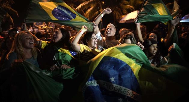 Supporters of Jair Bolsonaro celebrate in front of his residence in Rio de Janeiro, Brazil, Sunday, Oct. 28, 2018. 