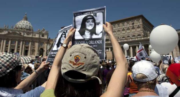 In this May 27, 2012, file photo, demonstrators hold pictures of Emanuela Orlandi reading 