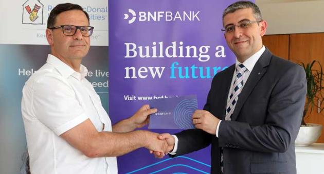 George Debono, Chief Commercial Officer at BNF Bank with Martin Xuereb, Chairperson of RMHC Malta