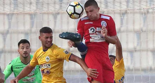 Gudja's Zack Cassar (front) is strongly engaged in ball tussle with his long-time friend Nick Borg (back) of Santa Lucia. Photo © Domenic Aquilina