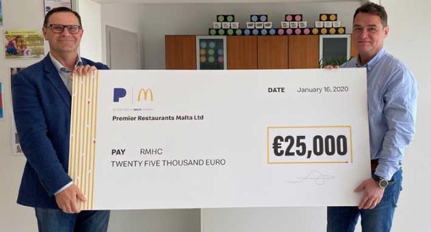 Martin Xuereb Chairman of RMHC (left) receiving the donation cheque from Paul Dragan, Managing Director of Premier Restaurants Malta.