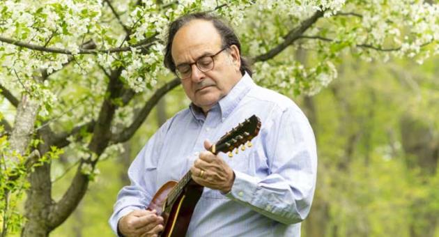 Prof. Michael Bugeja playing his mandolin at home in Iowa. Photo: Diane Bugeja