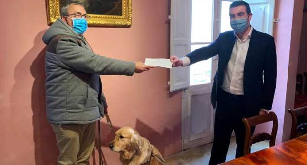 Mamo TCV Advocates managing partner Dr Michael Psaila presenting the donation to Malta Guide Dogs Foundation chairman Joseph Stafrace with his guide dog, Toby