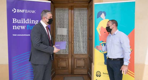 BNF Bank chief Commercial officer, George Debono presenting BNF’s donation to Andrew Zammit, Hospice Malta’s chief Relations officer