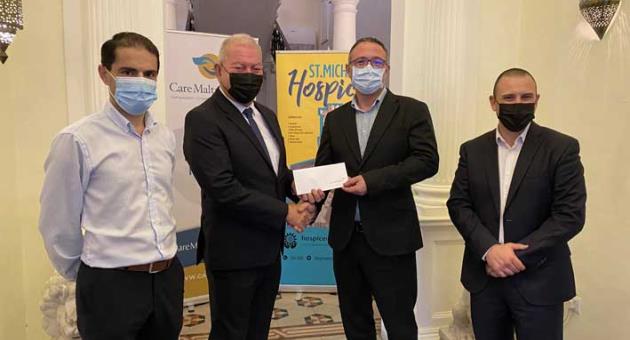 Vassallo Group chairman Nazzareno Vassallo presenting the CareMalta donation to Hospice Malta CEO Kenneth Delia in the presence of CareMalta director James Sciriha (left) and Hospice Malta’s chief relations officer Andrew Zammit