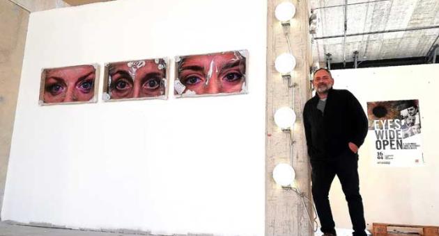 Artist G Luigi Rossi standing next to some of the artistic installations of his current exhibition