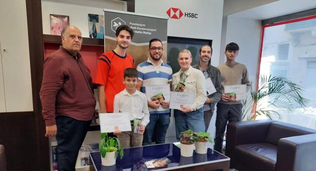 The ceremony was held at the HSBC Malta premises to award the winners. From left to right: Glenn Bugeja (representing the HSBC Malta Foundation), Dylan Farrugia (President of the KNM Foundation), Sebastian Said, Monika Gerdvilyte, Jorge Spiteri, Jake Desira. Front: Jeremy Bonello.