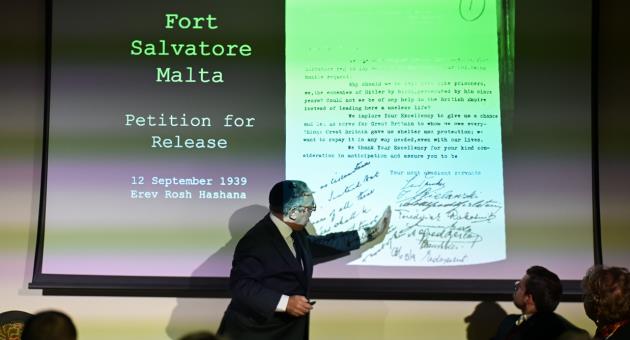 Sir Bernard Eder shows letter written by his father and other detainees from Fort S  Salvatore