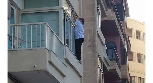 Photo of woman cleaning window on ledge goes viral The